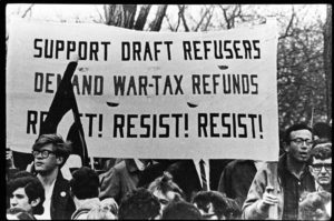 demonstrators with resist taxes and resist the draft banner