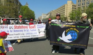 war tax resisters holding banner march alongside D.C. statehood advocates