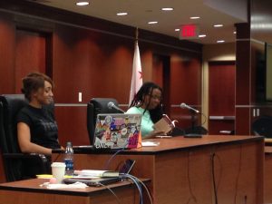Ciara Taylor (left) moderates the Tribunal while Esther Iverem (right) reads poems about the military, police, and violence from her book.