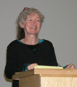 Kathy Kelly standing at a podium