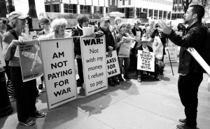 war tax protesters with their signs, including “I am not paying for war,” and “War: Not with my money. I refuse to pay.”