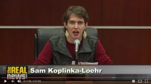 Sam Koplinka-Loehr, NWTRCC Field Organizer, testifies at a microphone at the Iraq Tribunal. 