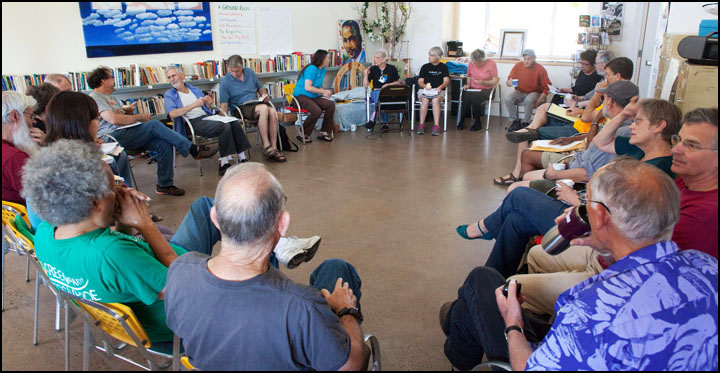 bright sun-lit room with 20 people sitting in chairs in a circle