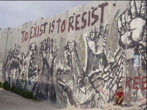 mural on a wall in Palestine, with the slogan 'to exist is to resist'