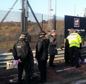 police speak to vigil particpants outside Faslane naval base, where Trident nuclear submarines are kept